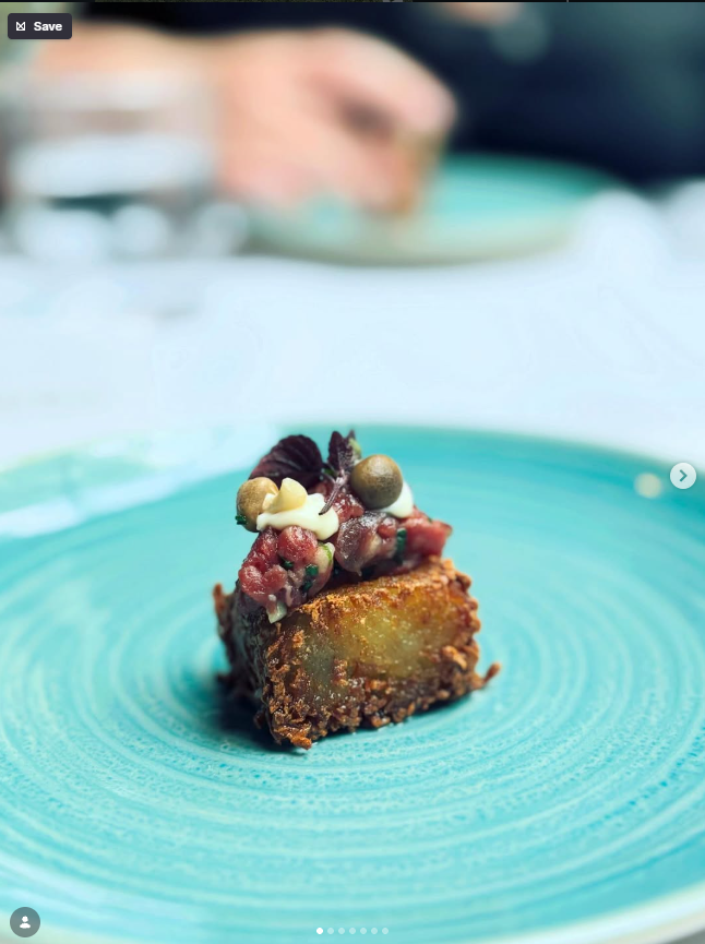 Illustrative plated dish with a crisp golden base on a turquoise plate